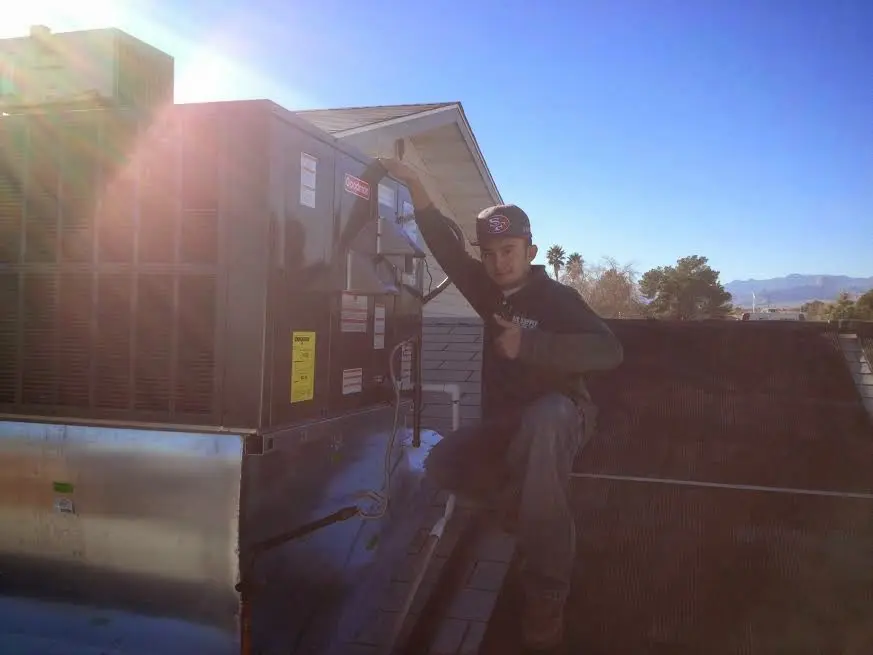 HVAC technician performing HVAC Inspection on a rooftop unit in Camden